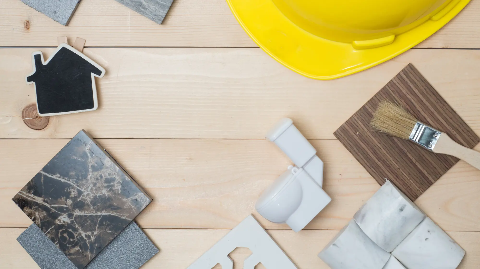 Kitchen and bathroom remodeling materials laid out on wood